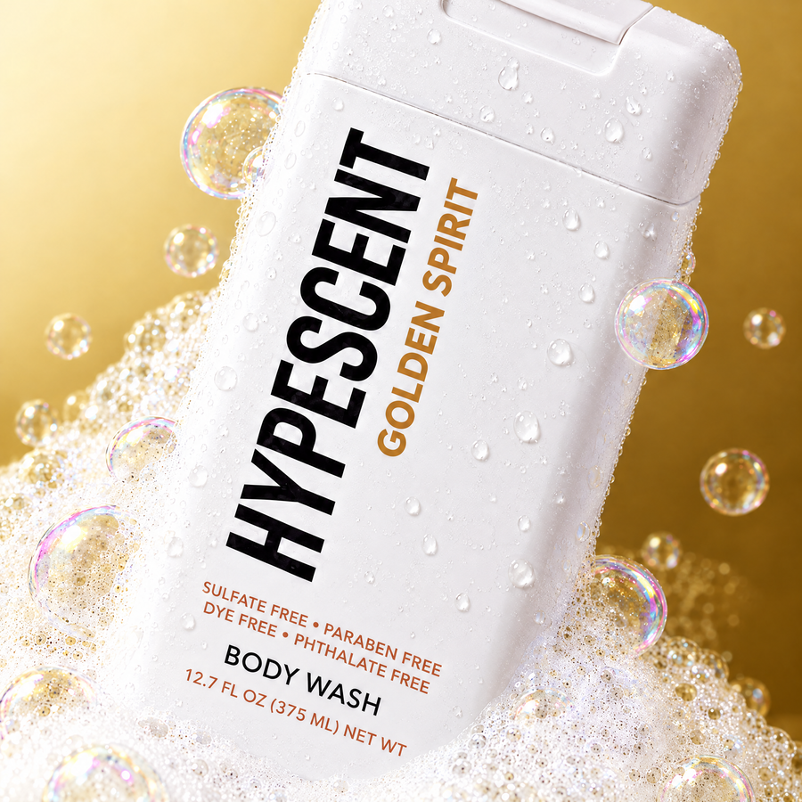Close-up of the HYPESCENT Golden Spirit body wash label with rich foam and bubbles