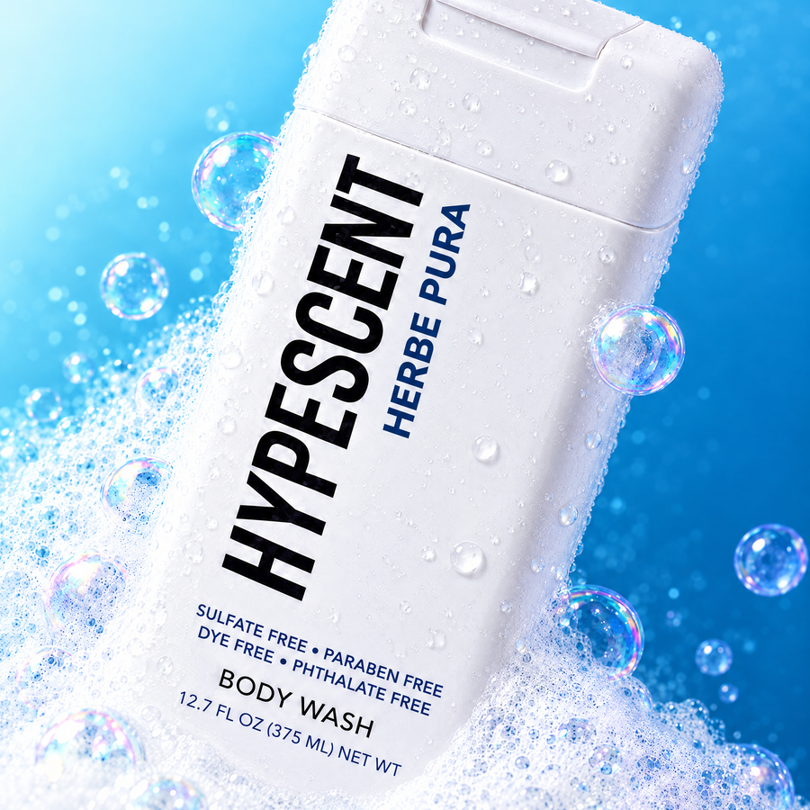 Close-up of the HYPESCENT Herbe Pura body wash label with rich foam and bubbles