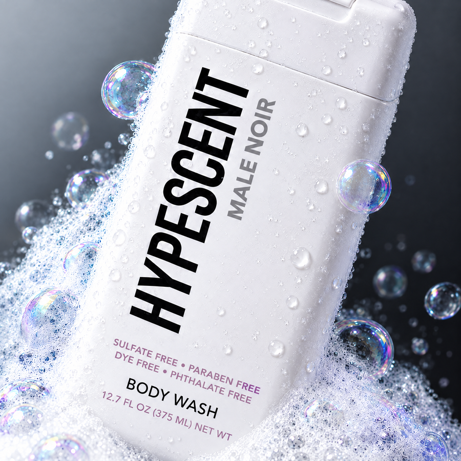 Close-up of the HYPESCENT Male Noir body wash label with rich foam and bubbles