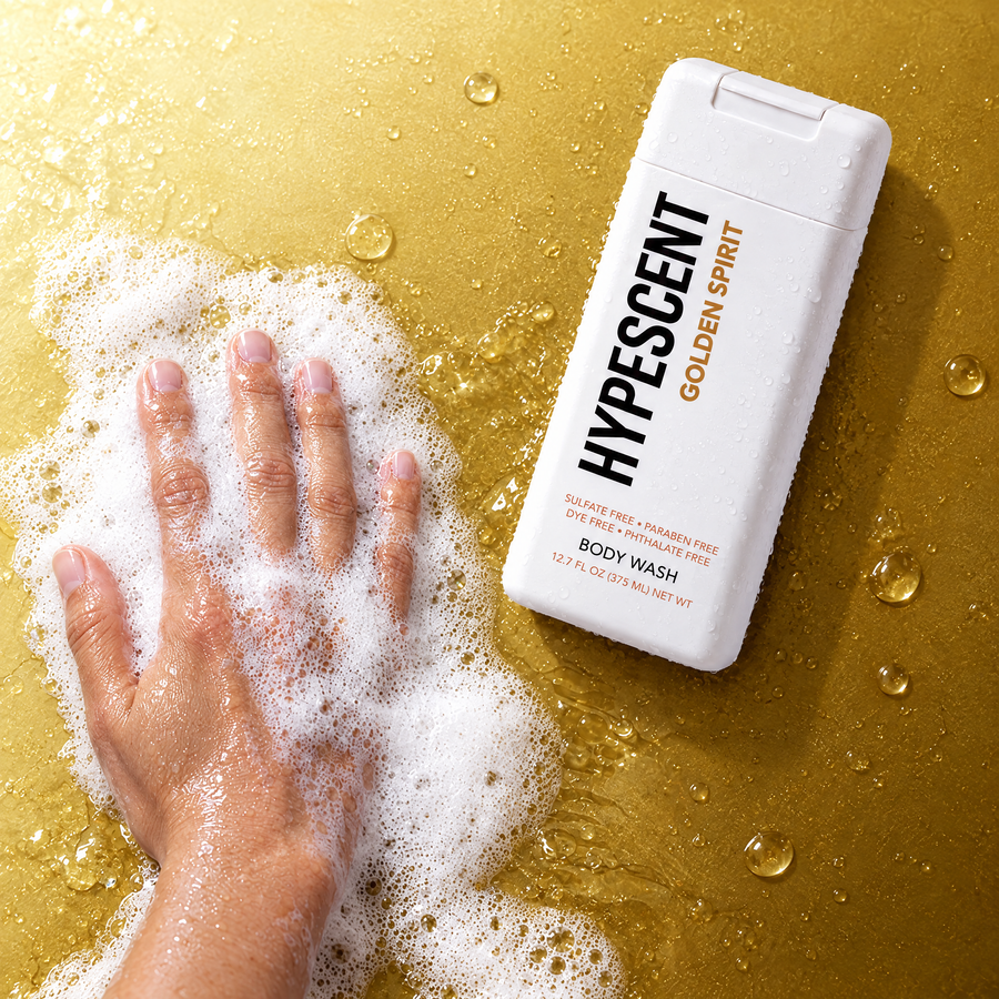 Hand lathering HYPESCENT Golden Spirit body wash into a rich foam