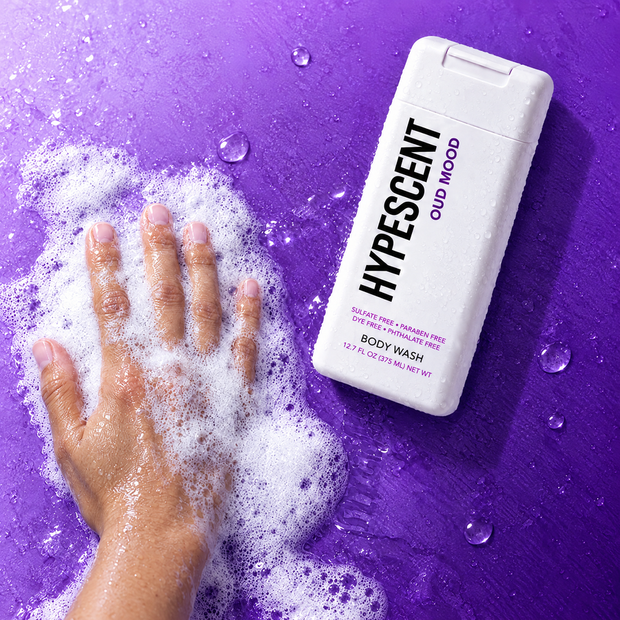 Hand lathering HYPESCENT Oud Mood body wash into a rich foam