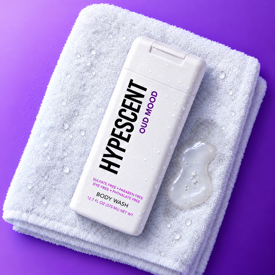 HYPESCENT Oud Mood body wash bottle on a white towel next to a drop of clear gel