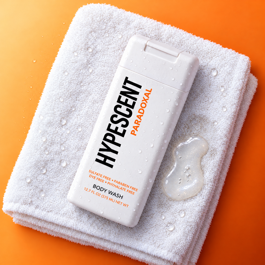 HYPESCENT Paradoxal body wash bottle on a white towel next to a drop of clear gel