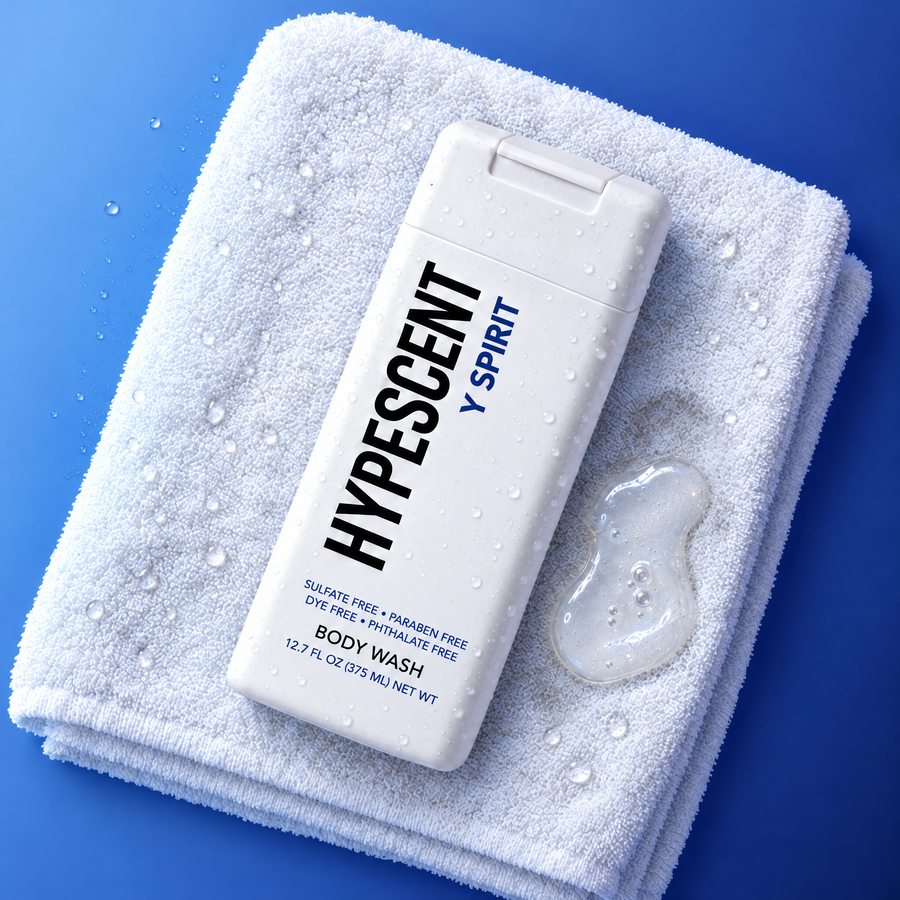 HYPESCENT Y Spirit body wash bottle on a white towel next to a drop of clear gel