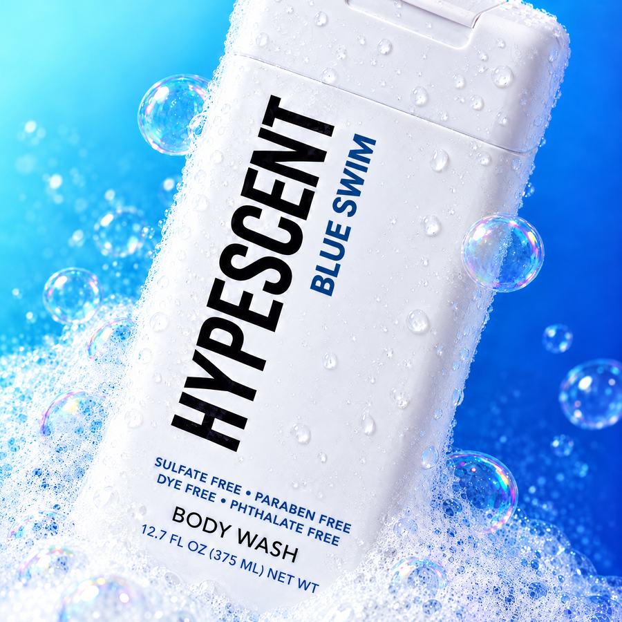 Close-up of the HYPESCENT Blue Swim body wash label with rich foam and bubbles