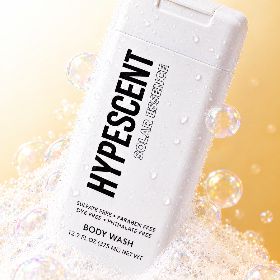 Close-up of the HYPESCENT Solar Essence body wash label with rich foam and bubbles
