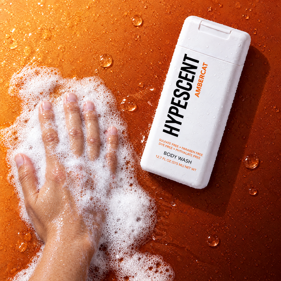 Hand lathering HYPESCENT Ambercat body wash into a rich foam