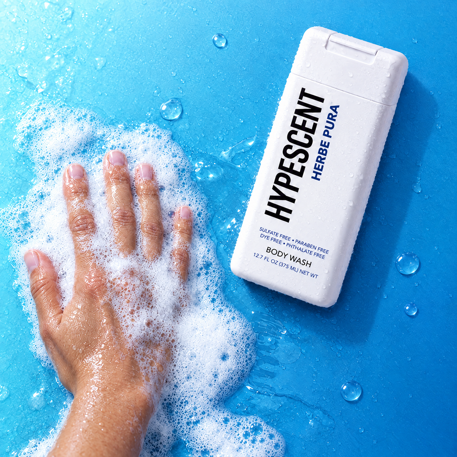 Hand lathering HYPESCENT Herbe Pura body wash into a rich foam