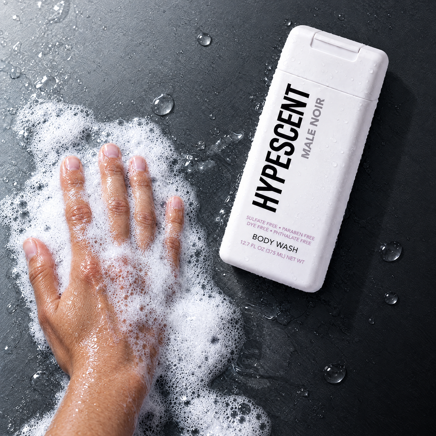 Hand lathering HYPESCENT Male Noir body wash into a rich foam