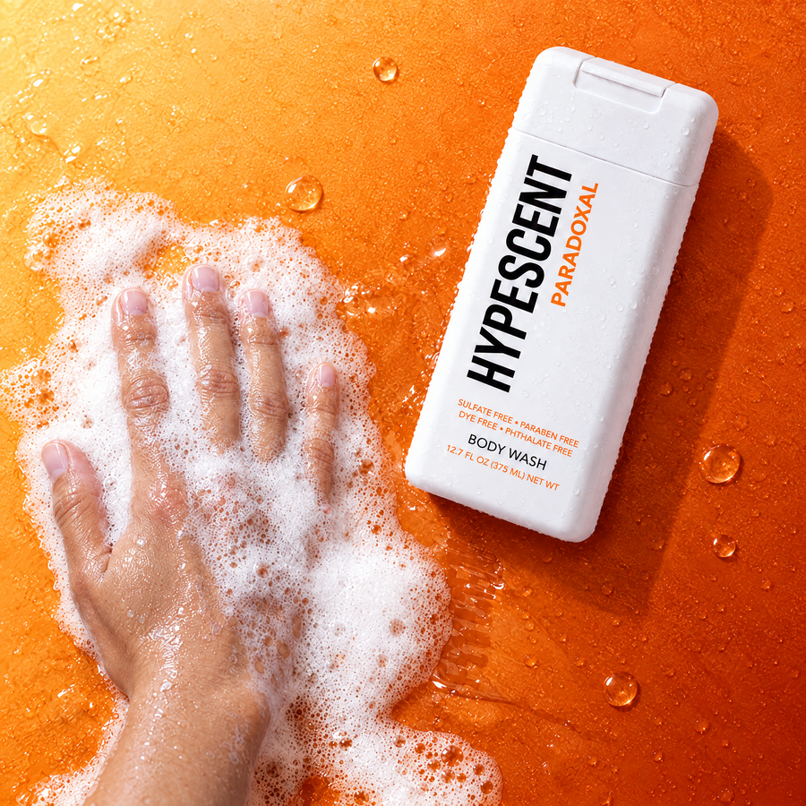 Hand lathering HYPESCENT Paradoxal body wash into a rich foam